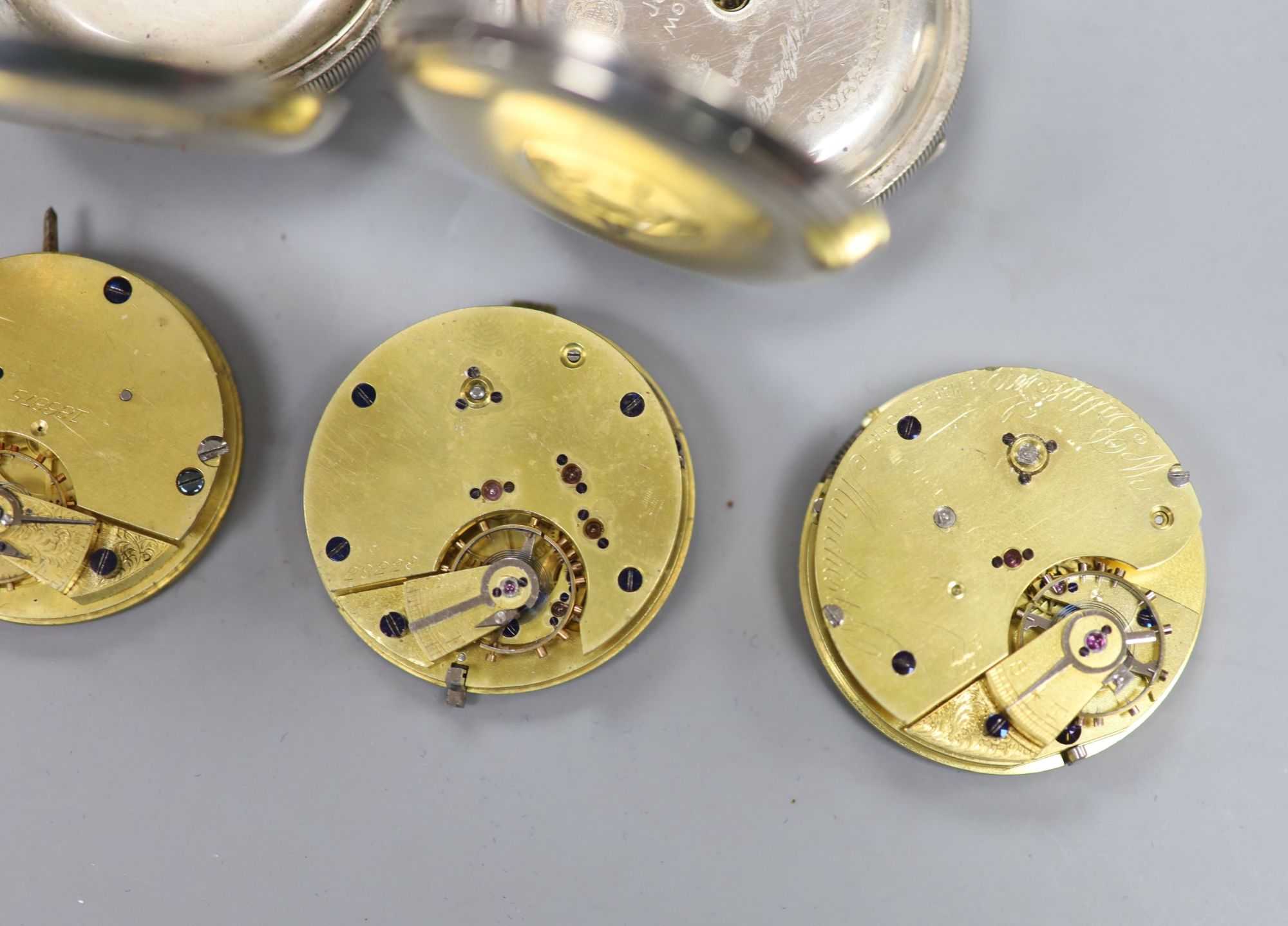 Two early 20th century silver or white metal pocket watches and four assorted pocket watch movements.